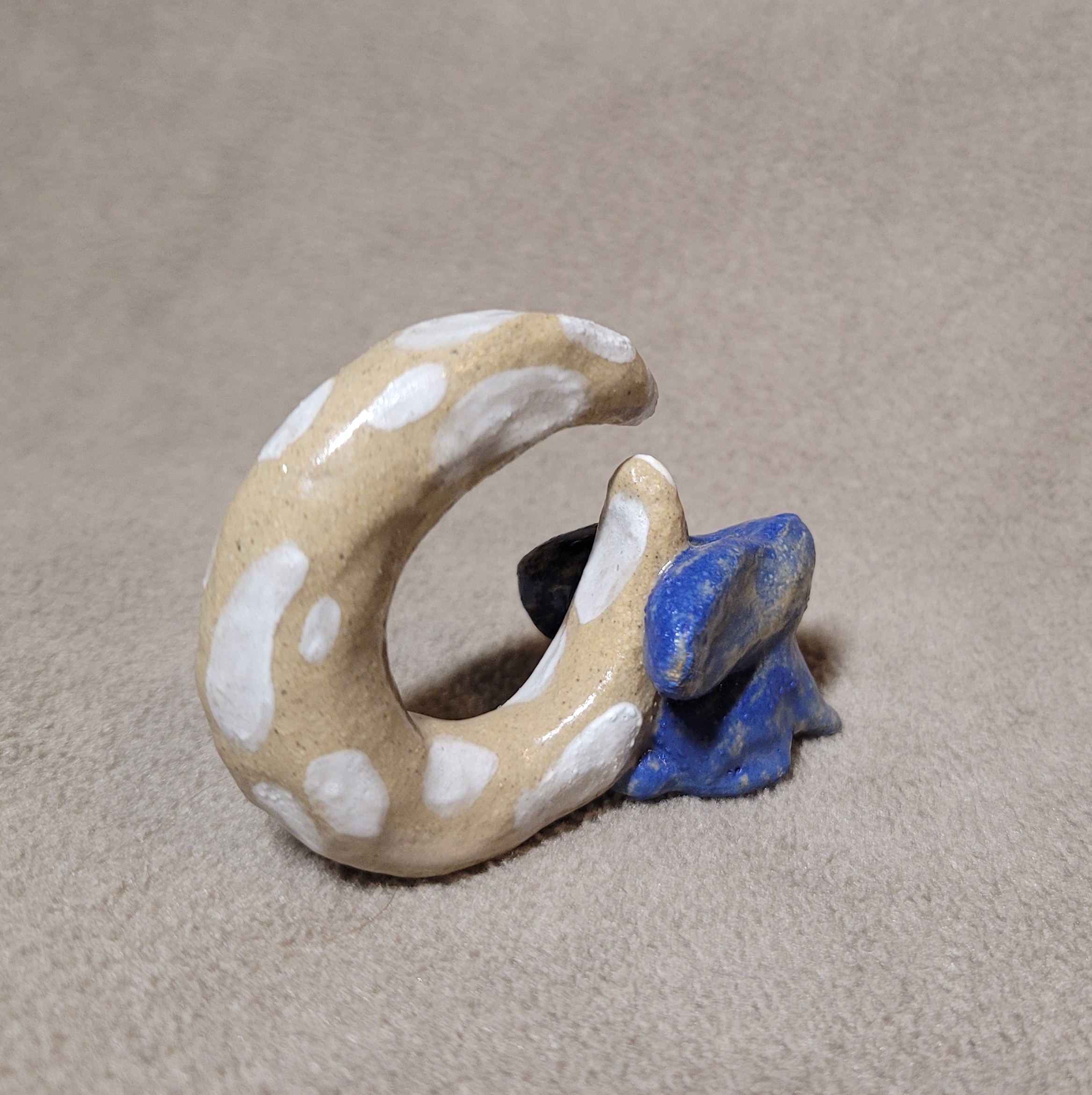 Blue ceramic bunny with a big creamy-white moon resting on its back